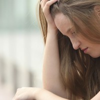 Teenager girl sitting outdoor depressed